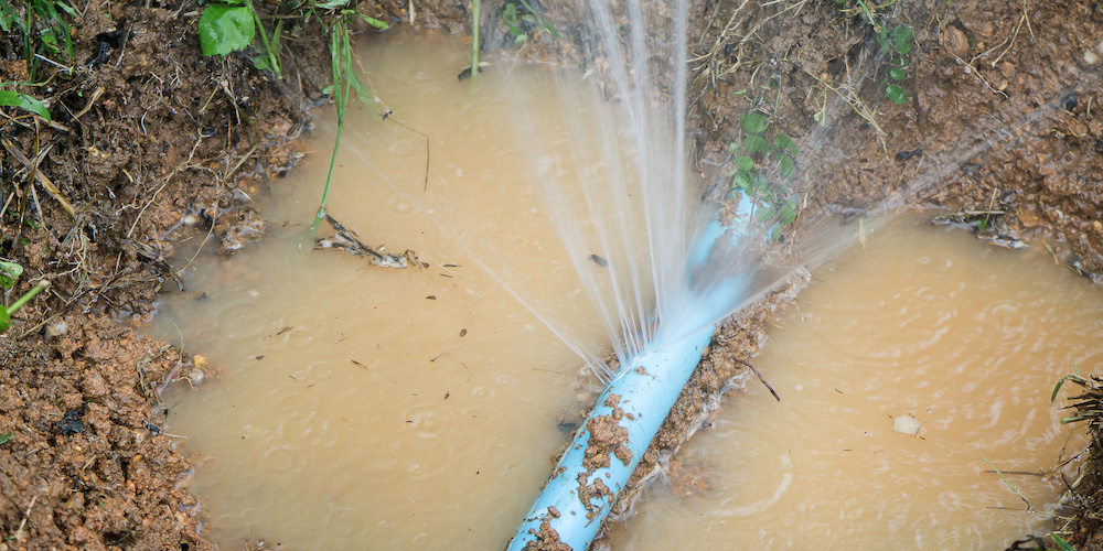 Water pipe break, leaking from hole in a hose,selective focus